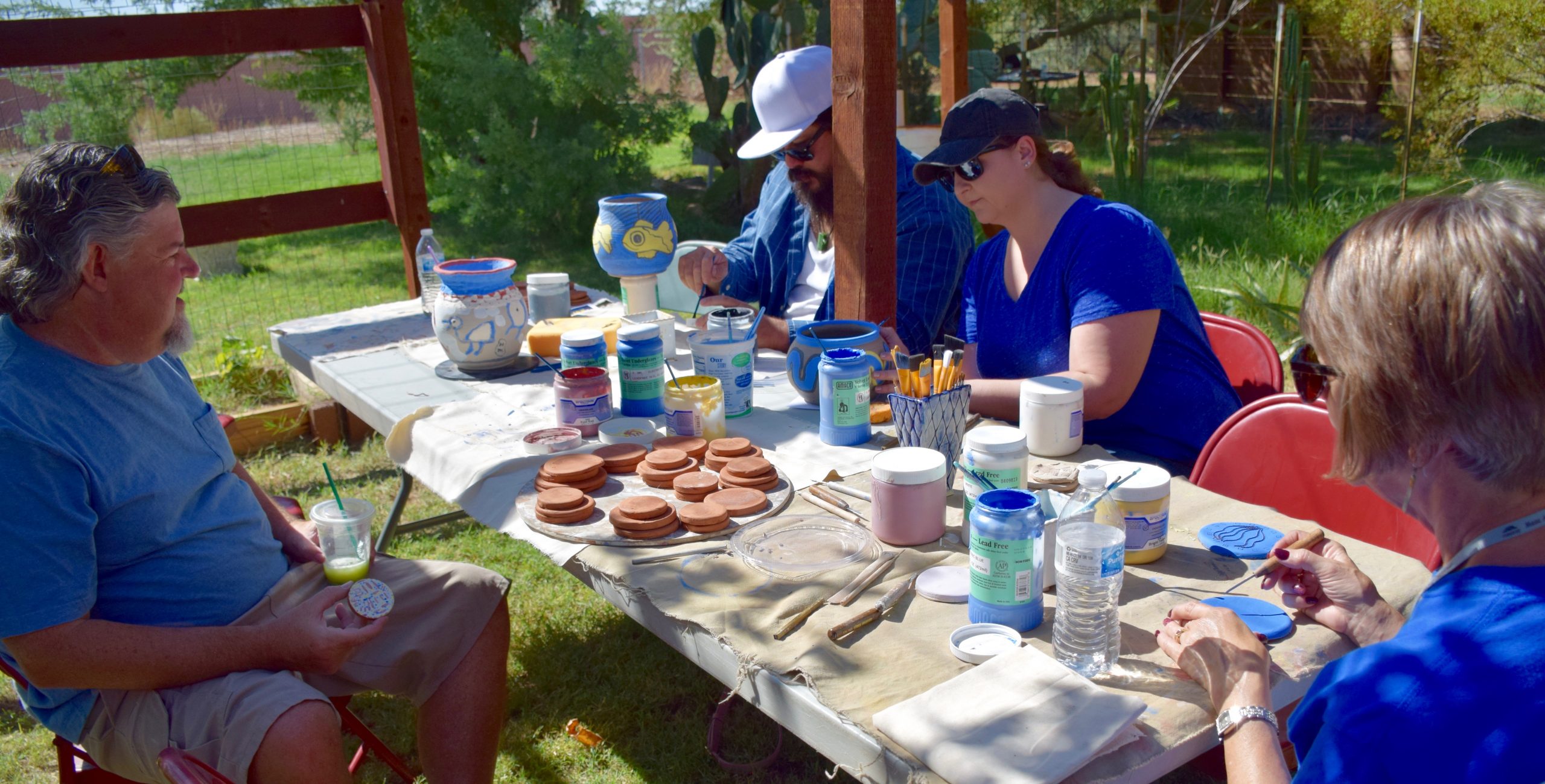 Community members painting ceramic disks for the project.