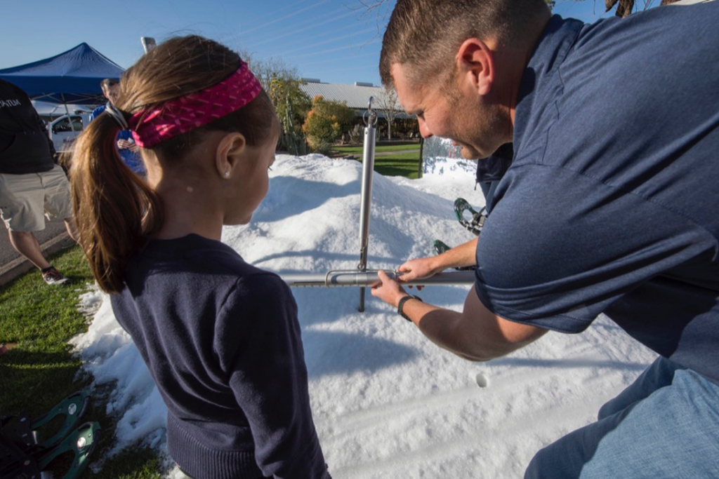 Andrew Volkmer (SRP) demonstrates how to measure snowpack at the SRP Water Conservation Expo.