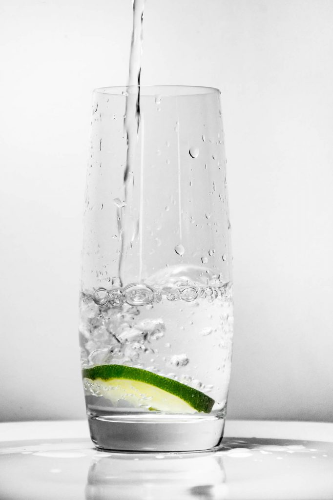 Resolve to Save Water: Glass of water being poured over ice and a lime