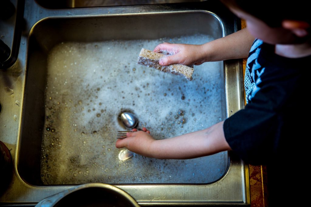 Solar Water Heater: Boy Washing Dishes